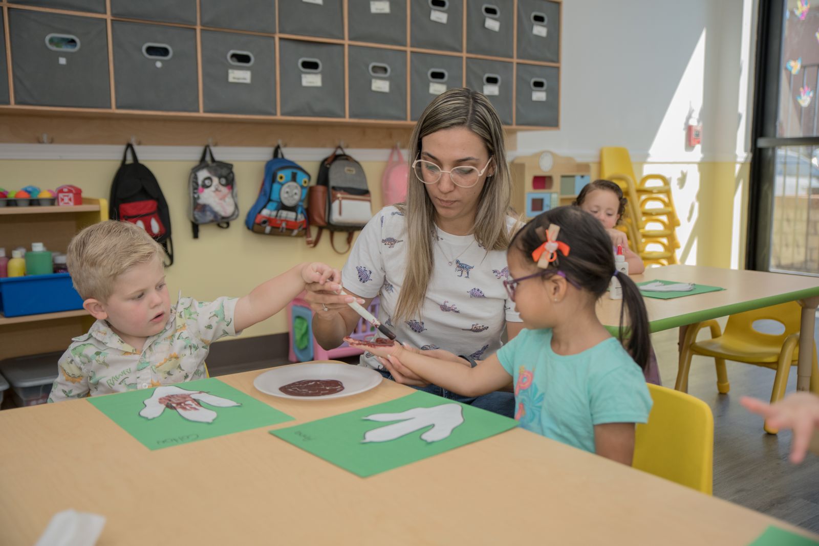 A MyPlace teacher working one-on-one with a small group of children
