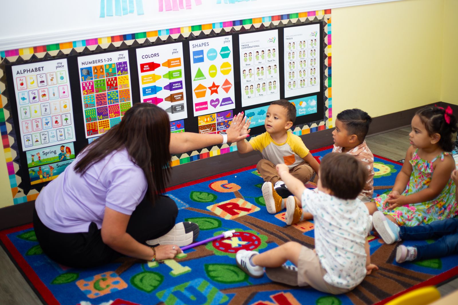 A teacher connecting with children in a small class at MyPlace