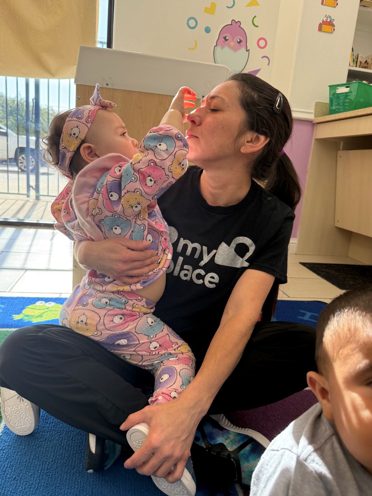 A long-tenured MyPlace teacher with a child